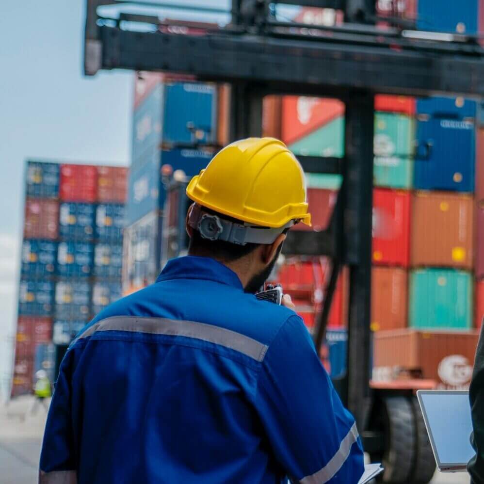 Workers discussing cargo container operations