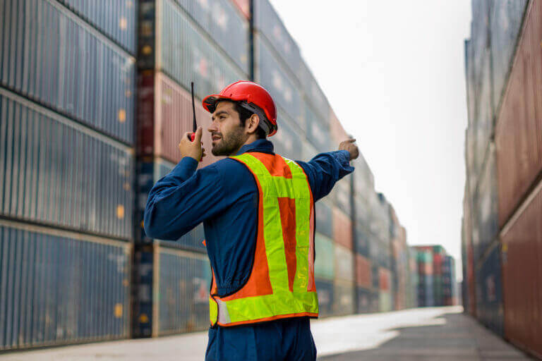 Worker inspecting cargo containers
