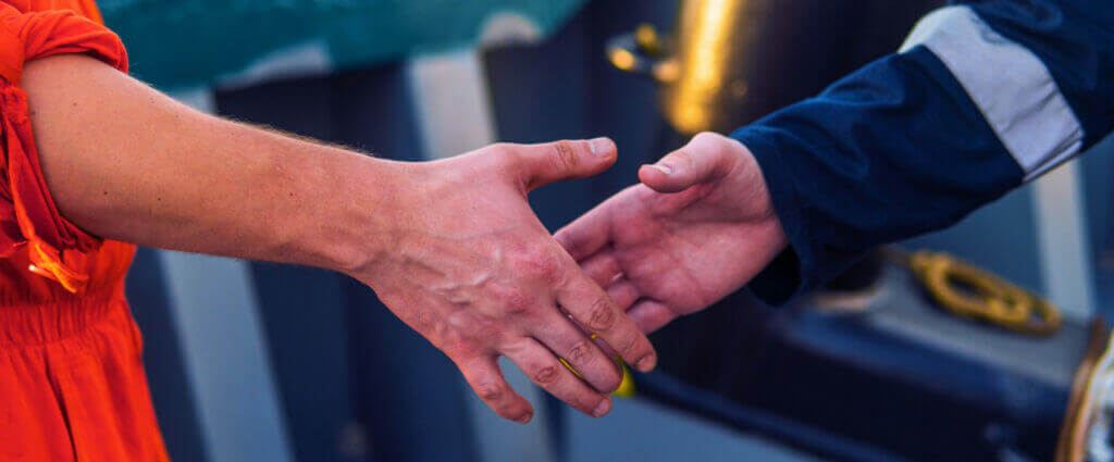 Marine contractor and worker shaking hands