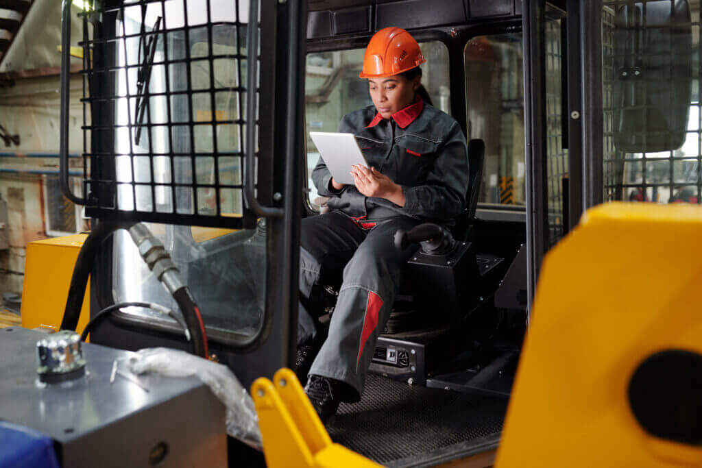 Factory worker reviewing technical information on a tablet